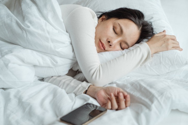 woman sleeping with phone