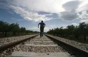 A man running on rail tracks